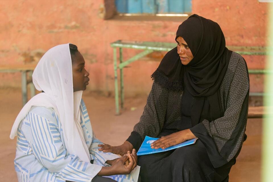 Walaa, 15, meets with Noha, a counselor at the UNICEF-supported Alshargia safe learning space in Kassala State, Sudan.