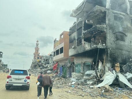 On March 19, 2024, following the recent escalation of violence in Khan Younis, southern Gaza Strip, pedestrians and a UNICEF-marked vehicle travel on a road impacted by the conflict.