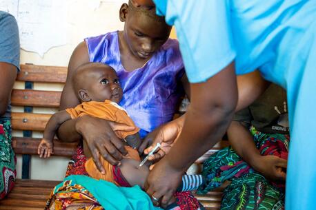 A community health worker administers the malaria vaccine to a child at Chileka Health Center in Lilongwe district, Malawi.