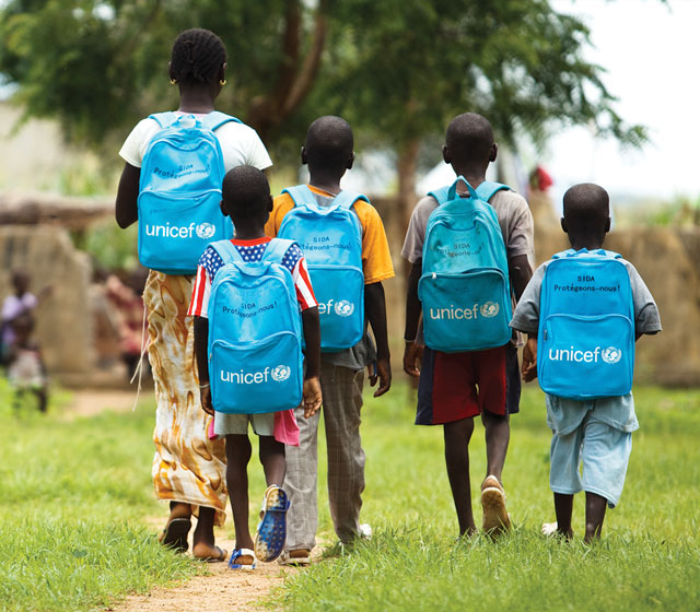 Children wearing UNICEF backpacks arrive at the Fatao primary school in the village of Fatao, Mali on Tuesday August 31th