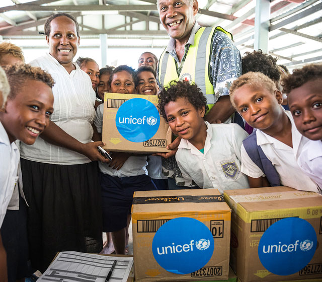 A school teacher, students of White River School in Honiara and a staff member of Red Cross holding a box with soap and other hygiene items provided to the school by UNICEF. This took place during a workshop organised by UNICEF with their partners from the Red Cross