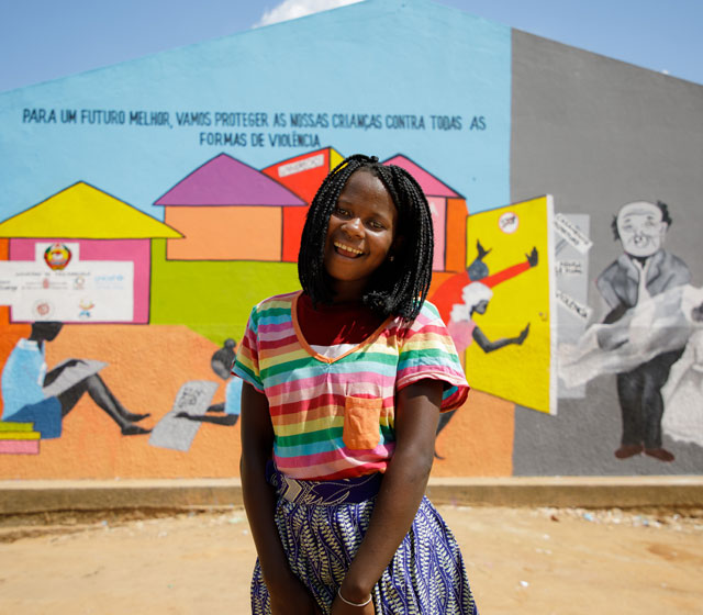 Marla Assane 14 YEARS OLD, Student of Rapale School standing in front of a mural NAMPULA PROVINCE, MOZAMBIQUE, NOVEMBER 2021.