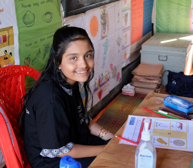 10-year-old Bushara sits at the teacher’s table in a learning centre on 10 November 2021