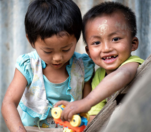 Two children playing outside at Lauk Lung village, 10 Miles away from Hakha where children get polio vaccination from the midwives. Chief of Office and Daniele (the photographer) shared health awareness and the impact of hard labour to the mother and others gathered in the village.