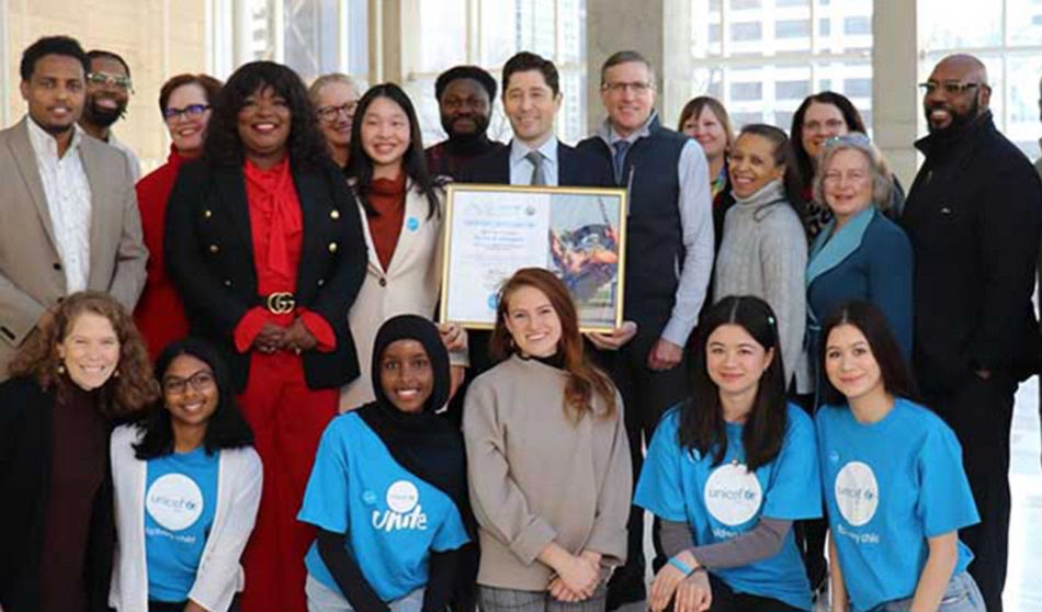 Mayor Frey and UNICEF USA CEO and President Michael J. Nyenhuis are joined by local CFCI partners, youth leaders and staff to celebrate Minneapolis's recognition as a UNICEF Child Friendly City on February 14, 2024 at the Minneapolis Public Service Building