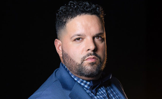 Portrait photo of Fernando Varela in a blue suit