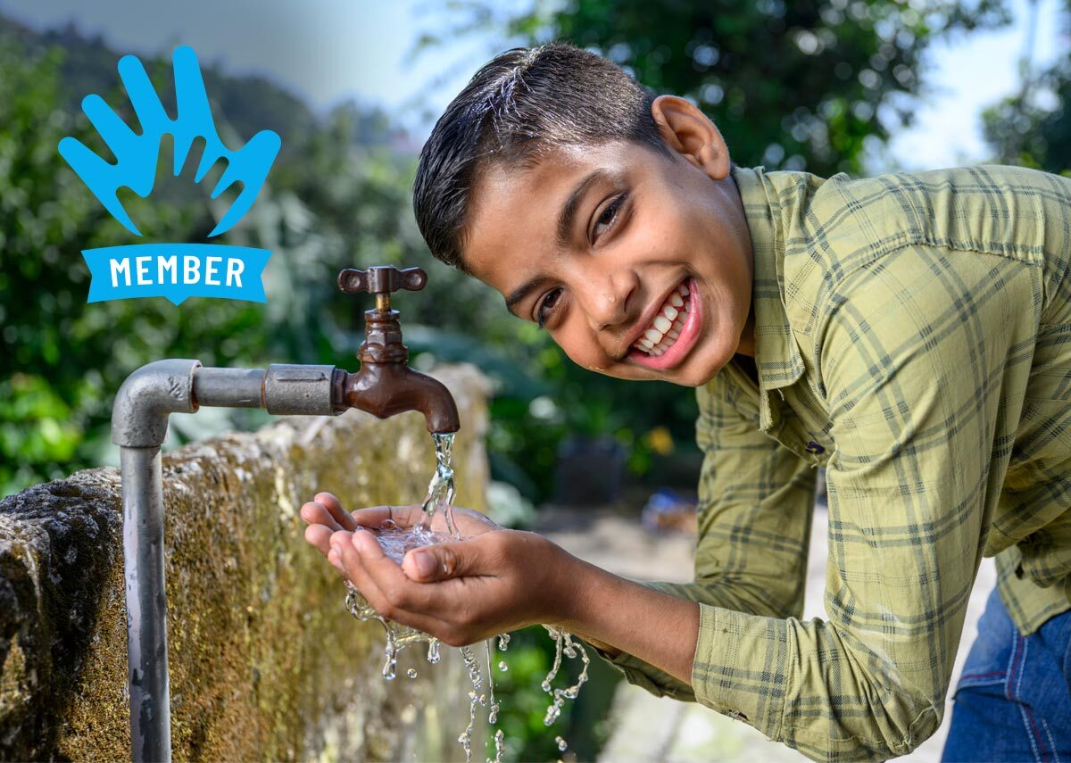 Happy child  drinking water from tapped water connection provided to his village house by JJM. Location : Village Bathol, Solan, Himachal Pradesh, India