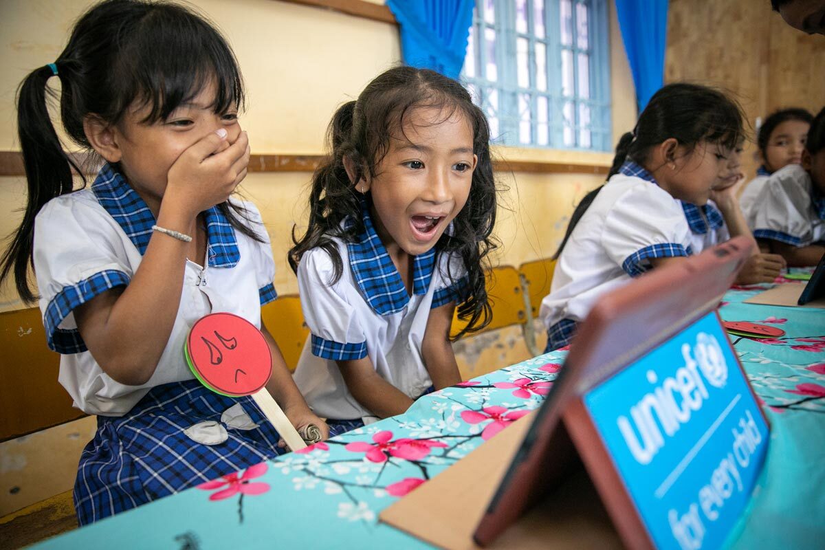 Mai and Lam, 8 years old, Khmer students from Long Phu C primary school (Long Phu district, Soc Trang province, Viet Nam) are happily experiencing a digital book.