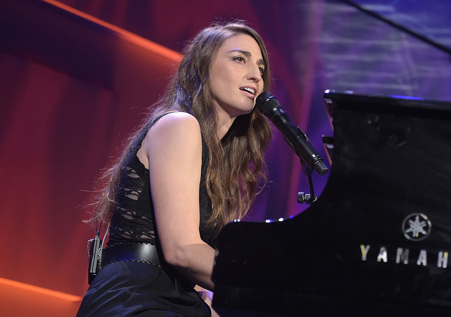 Sara Bareilles performs on the piano on stage