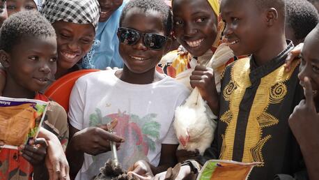 Amadé, 13 (in sunglasses) learns how to vaccinate poultry in a program supported by Education Cannot Wait and UNICEF in Ouahigouya, Burkina Faso. 