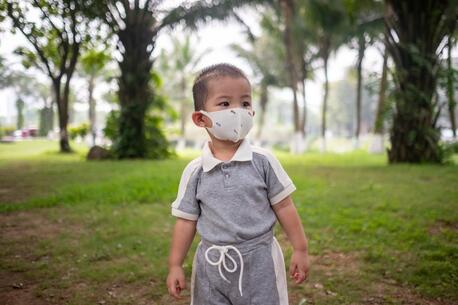 A 3-year-old boy walks through a park in a residential neighborhood of Hanoi, Vietnam, ranked the 8th most polluted city worldwide, closely trailing Jakarta.