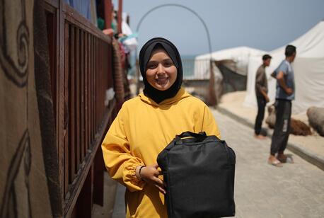 Raghad, 17-year-old, displaced from Khan Younis, receives the Adolescent Girls Care and Protection Package distributed by UNICEF and its partners in Rafah, Palestine.