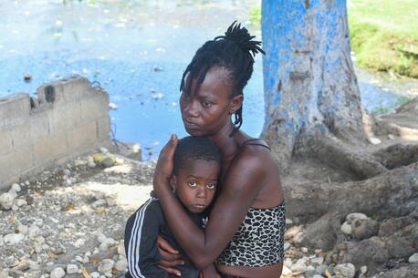 A mother holds her child close in Haiti, where escalating violence is pushing more and more families from their homes. 