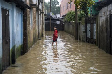 A girl stands in a flooded street in Sylhet, North-East Bangladesh.