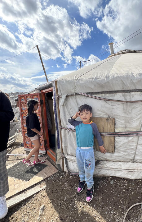 A 4-year-old boy greets visitors outside his home in the outskirts of Ulaanbaatar.