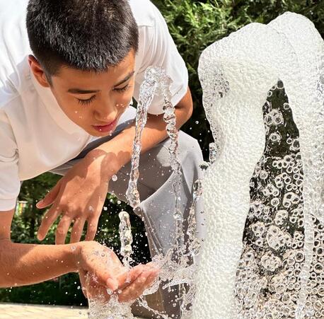 Khurshed, 13, stays cool on his way home at the fountain at the Spartak park when temperatures reach 35 degrees Celsius in Dushanbe, Tajikistan, in early July., 2024