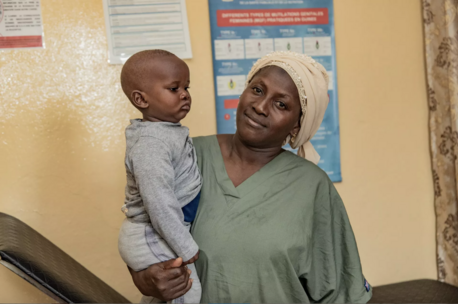 Aissata Dambélé, a nurse, holds 9-month-old Mohamed at Bernay-Fotoba health center in the Matoto commune of Conakry, Guinea.