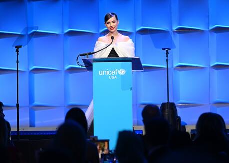 UNICEF USA Ambassador Sofia Carson stands at the podium to speak in support of UNICEF at a UNICEF USA fundraising event.