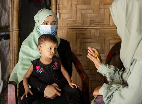 On July 15, 2024, UNICEF-trained Rohingya community nutrition volunteer Taslima visits Noor Bibi, 28, to provide nutrition counseling and to assess the nutritional status of her daughter Jishan, 2, at their shelter in the Rohingya refugee camps in Cox’s Bazar, Bangladesh.