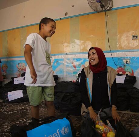 UNICEF early child development officer Fairoo Abuz Warda shares a moment with a child in the Gaza Strip.