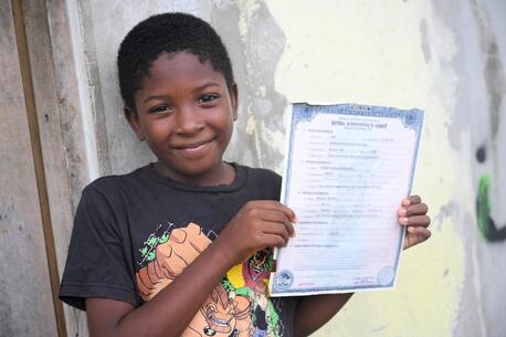 A 9 year old boy, with his birth certificate, in Belize City.