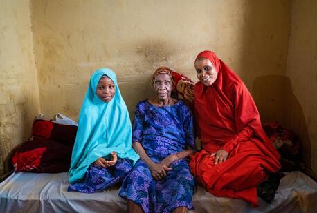 Fatima Habibu, 99, sits with her granddaughter, right, a volunteer community mobilizer, and great-granddaughter in Katsina, Nigeria.