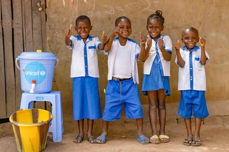 Students at Ecole Primaire Ilako in Mbandaka, Democratic Republic of the Congo, stand outside their classroom after washing their hands. UNICEF installed handwashing stations at the school to help students protect themselves from Ebola.