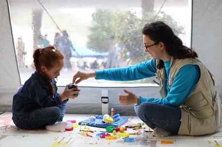 Heghine Ghukasyan, UNICEF Focal Point in Syunik, plays with Viktoria, a child displaced from Karabakh, in a child corner, part of a child-friendly space established by UNICEF Armenia in Goris.