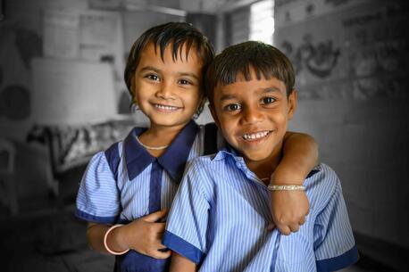 two friends in their UNICEF-supported classroom