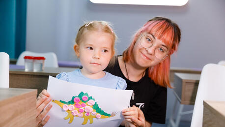 May 24, 2024, Dnipro, Ukraine. A girl shows her drawing at an art therapy class at the multifunctional centre in Dnipro.