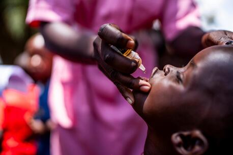 A child in Uganda receives the oral polio vaccine.