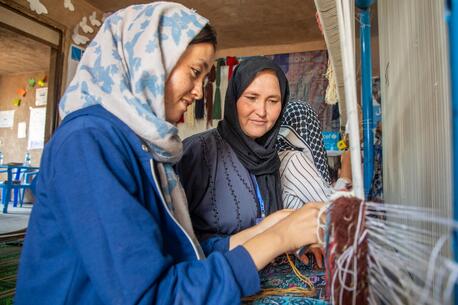 A young woman learns carpet weaving in a vocational training course in Herat, Afghanistan, supported by UNICEF with funding from the Government of Japan.