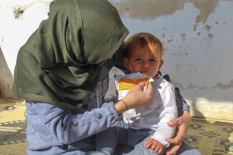 In Obada village, Rural Damascus, Syria on Dec. 17, 2024, a mother feeds her 1-year-old son a preventive food supplement distributed by UNICEF.