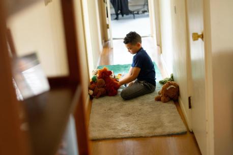 Luka, 8, plays with stuffed animals in between completing school work on his first day learning from home after his school in Connecticut closed due to the coronavirus outbreak. 