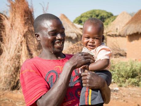 One-year-old baby Moses and father Ponsilio Phiri playing in Zambia in 2020. Baby Moses is enrolled in the LEGO Playful Parenting program implemented by UNICEF.
