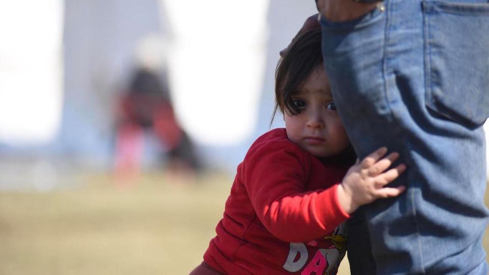 A child hides behind her father in Kahramanmaras, Turkey, five days after a pair of deadly earthquakes hit Turkey and Syria. 