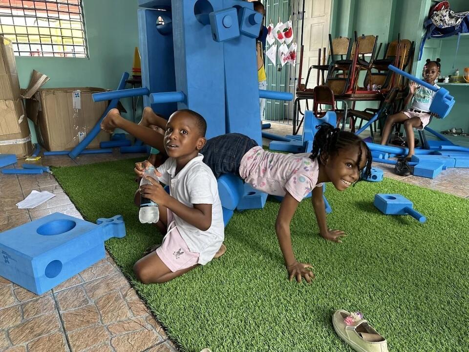 6-year-old Khaheel and 7-year-old Sahria play with blue blocks at a summer camp at Higholborn Street Basic school in Kingston, Jamaica.