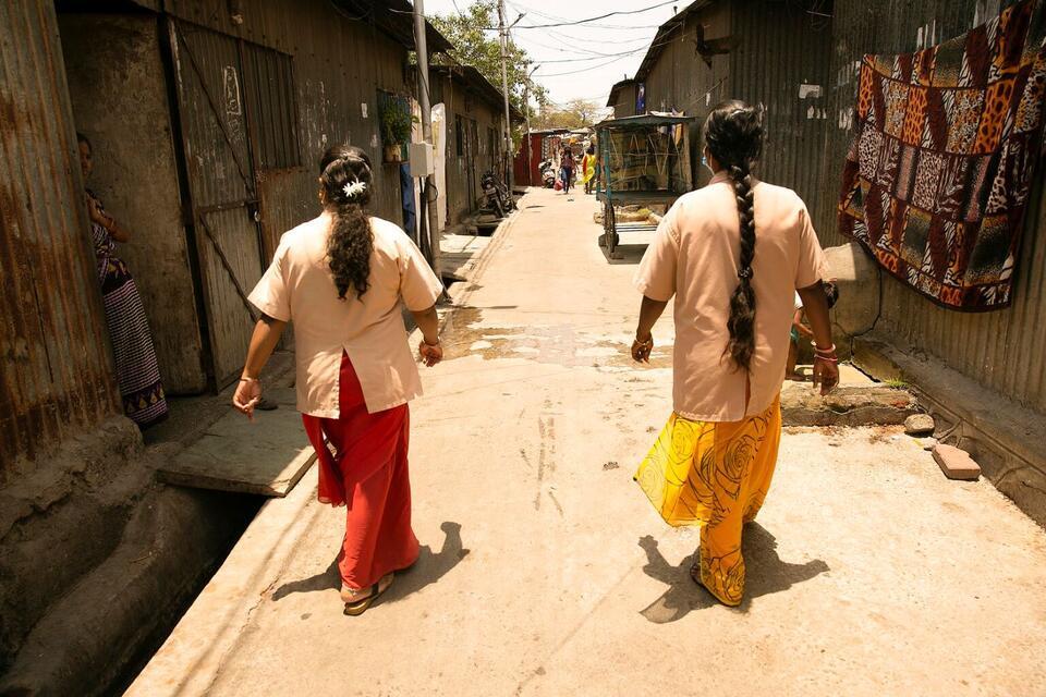 Two Accredited Social Health Activist (ASHA) workers make the rounds in the Ajanta Nagar slum in Pimpri, Maharashtra. They keep track of houses in which children need health care.