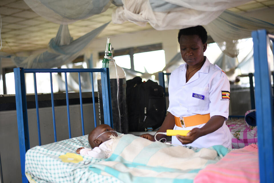 Nurse tends to a child with pneumonia in Uganda