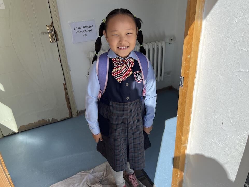 A young girl in Mongolia heads off to school.