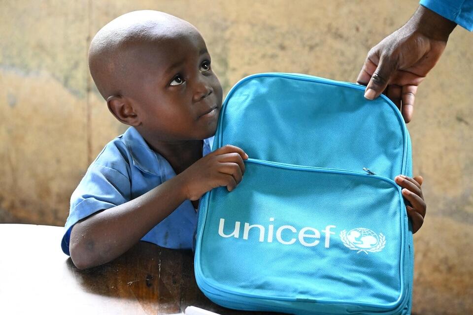 A young boy receives a UNICEF book bag in the town of Limbe, in the embattled Southwest Region of Cameroon.