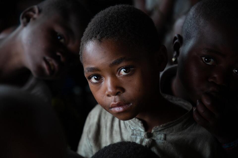 On June 1, 2024 in the Democratic Republic of the Congo, children stand together during a cooking demonstration and malnutrition screening at a UNICEF-supported nutrition center in the Bushagara site for internally displaced people on the outskirts of Goma. 