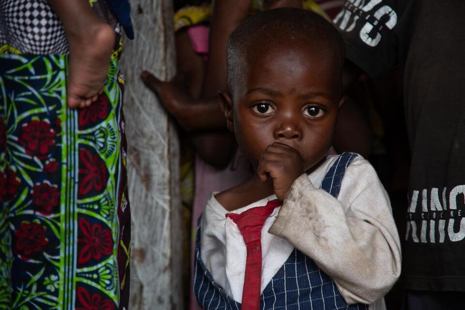 On June 1, 2024 in the Democratic Republic of the Congo, children stand in line for porridge during a cooking demonstration and malnutrition screening at a UNICEF-supported nutrition center in the Bushagara site for internally displaced people on the outskirts of Goma.