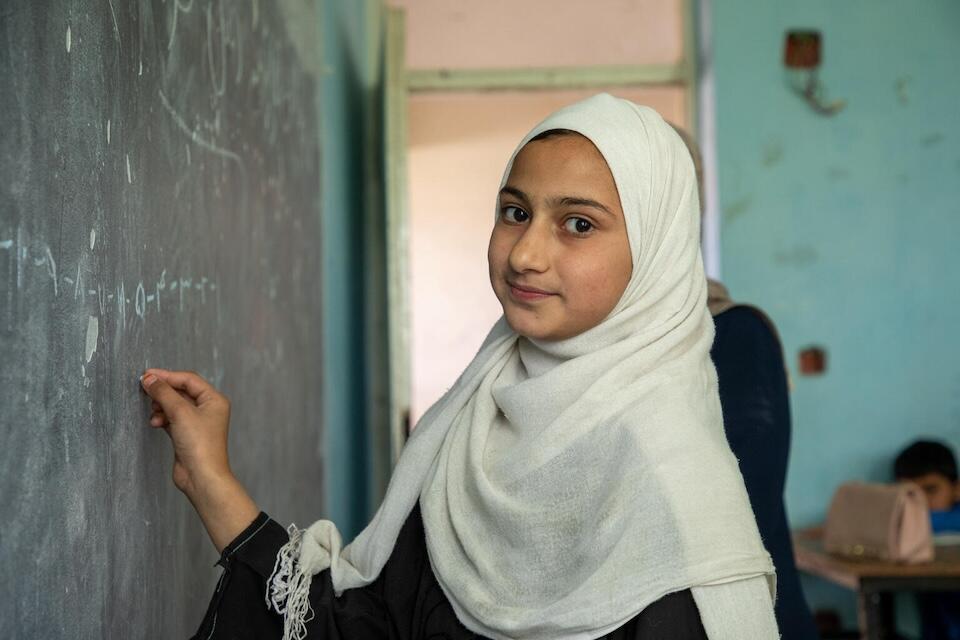 On June 11, 2024, a primary school student writes on the blackboard in her school in Kabul, Afghanistan.