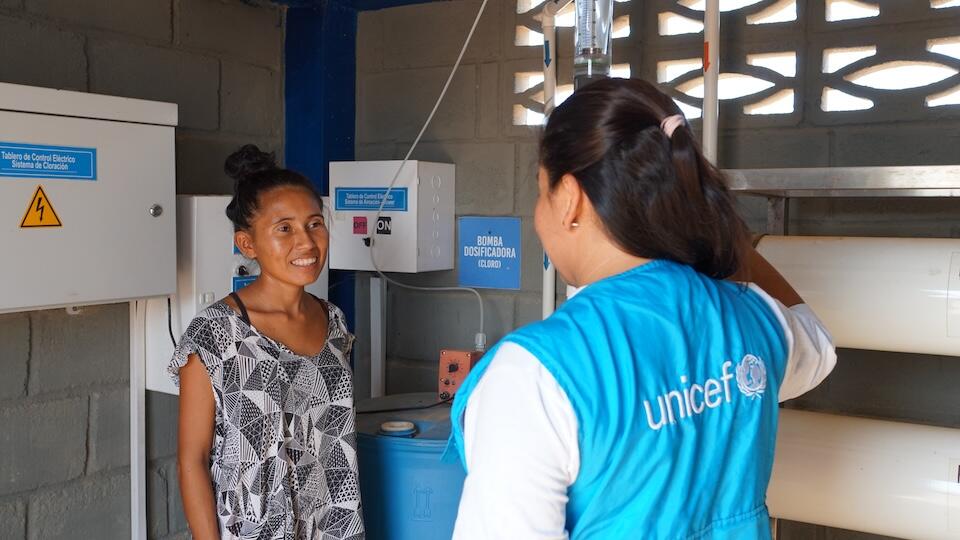 Estefany, who works as a plumber at her local water treatment plant, speaks with a UNICEF staff member in La Guajira, Colombia. 