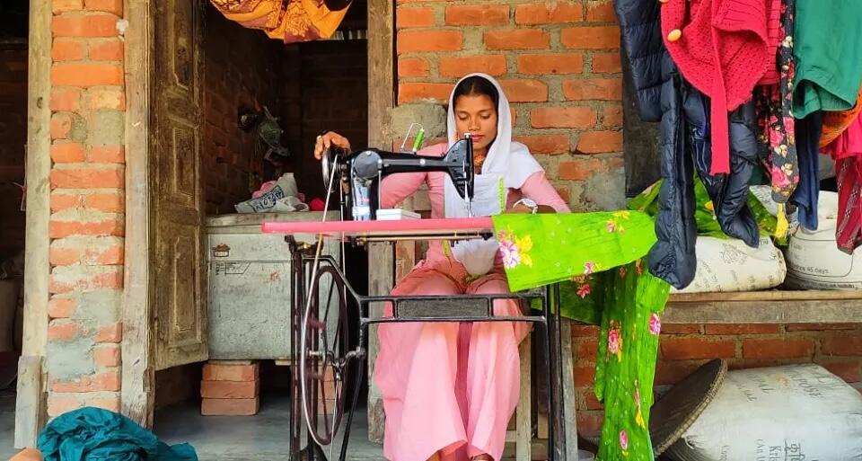 Sahira from Nepal, who gained job skills through a UNICEF-supported program, at her sewing machine.