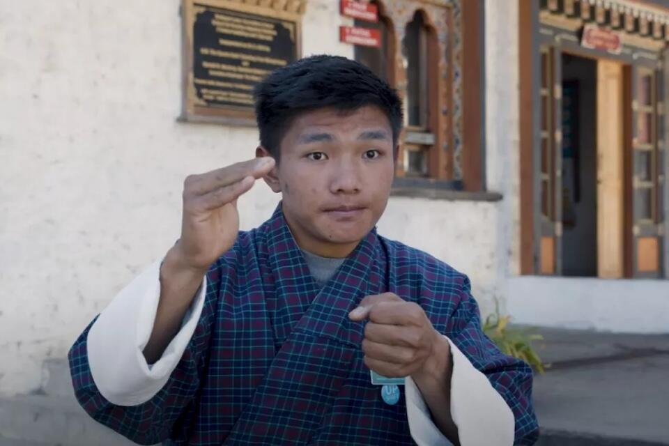 Tenzin, a student in Bhutan, shares his experience learning skills through a UNICEF-supported program through sign language.