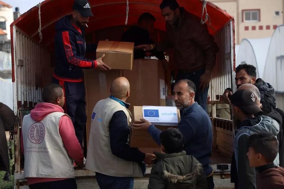 UNICEF and partners unload a truck of humanitarian supplies in the Gaza Strip.
