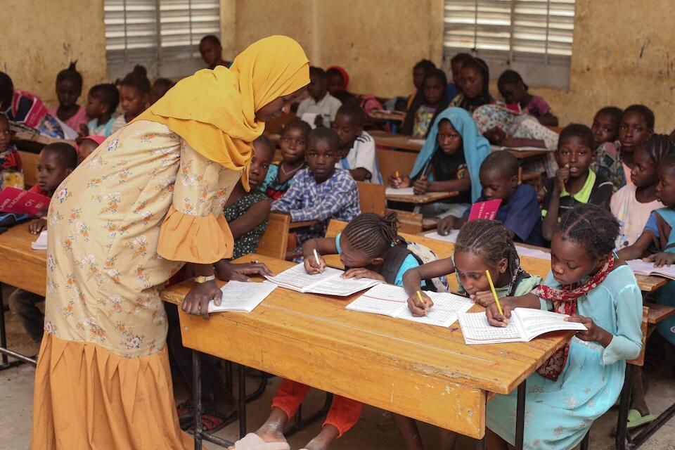 Students sit at long desks at a UNICEF-supported school in Timbuktu, Mali.