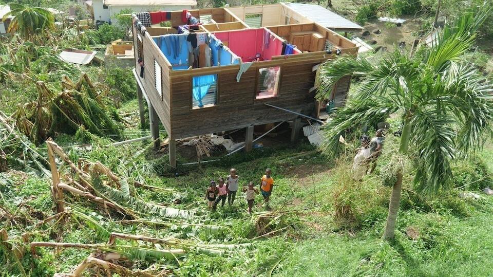 Children in Grenada stand outside their damaged home, a common sight in the days after Hurricane Beryl made landfall, tearing through the Caribbean region.